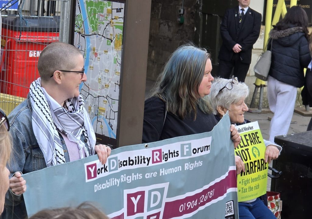 YDRF members hold up the YDRF banner at a protest