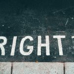 The question 'right?' written on the surface of a road